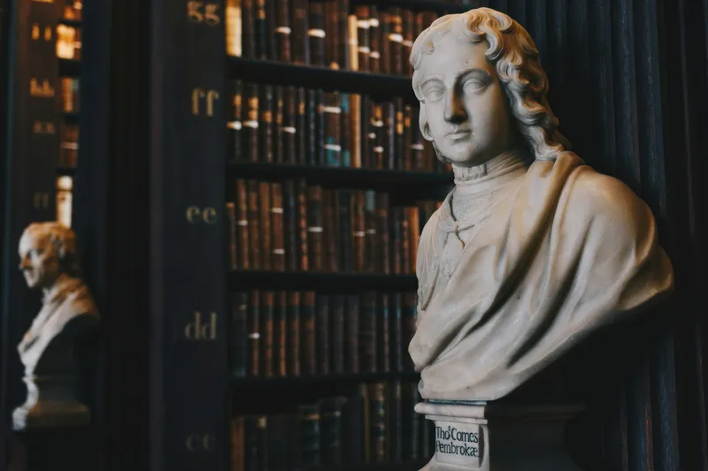 Marble bust among shelves of leather-bound law books